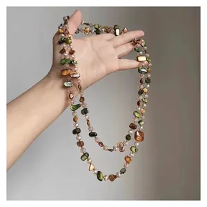 Handcrafted Bohemian shell beaded necklace with green and amber stones for ethnic vacation style
