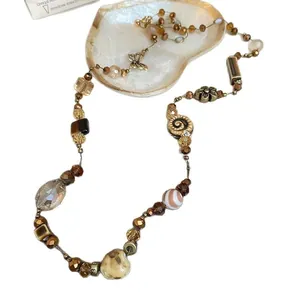 Bohemian shell beaded necklace with earth-toned crystals and butterfly charms for women