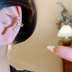 Close-up showing the elegant pearl and zircon non-pierced ear cuff worn on a female ear