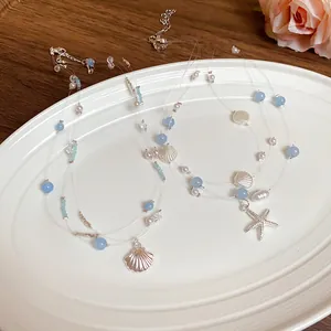 Multi-layer seashell and starfish necklace with blue beads for summer beach vacations.