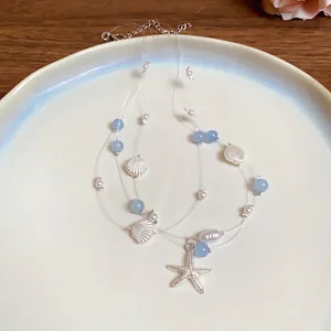 Multi-layer beach necklace featuring starfish shell pearl and blue beads on a plate