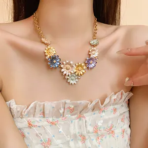 Detailed macro view of a colorful floral enamel necklace with sparkling rhinestones