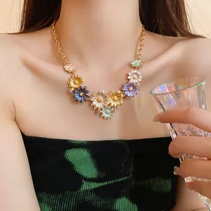 Detailed view of colorful enamel daisy necklace with rhinestones on model