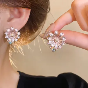 Exquisite pink enamel daisy earrings featuring a small sparkling crystal accent for women