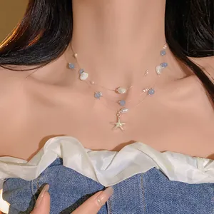 Detail view of multi-layer ocean-style necklace with starfish and pearls.