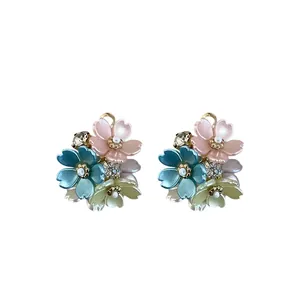 Elegant floral stud earrings with colorful petals and rhinestones on white background