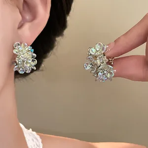 Close-up of sparkling iridescent floral earrings featuring a sweet French style design