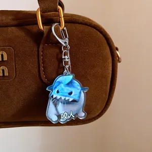 Close-up of a cute acrylic shark cat meme keychain hanging on a stylish brown suede handbag