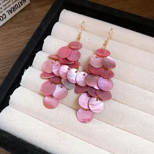 Elegant pink shell disc tassel drop earrings perfect for a sweet beach vacation style.
