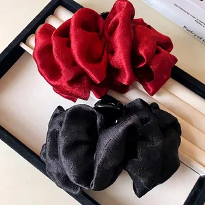 Elegant pleated fabric bow hair claw clips in red and black colors for hair styling