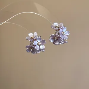 Detailed macro view of purple flower stud earrings with elegant sparkling crystals