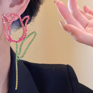 Detailed macro view of rhinestone tulip earrings with sparkling pink and green crystals