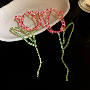 Detailed view of elegant tulip-shaped earrings with sparkling pink and green crystals.