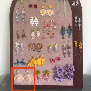 Detailed view of various Mori style earrings with floral, butterfly, and tassel designs.