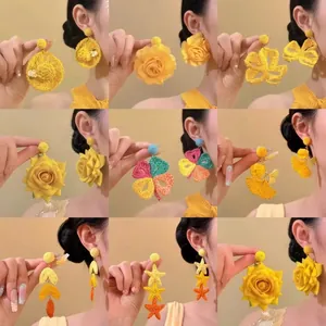Collage of colorful raffia woven flower and starfish pendant earrings for beach vacation