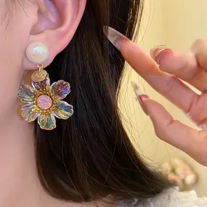 Vintage resin flower pendant earrings with iridescent petals and pink crystal center detail