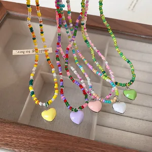 Colorful heart beaded necklaces in a wooden jewelry tray, fresh sweet design.