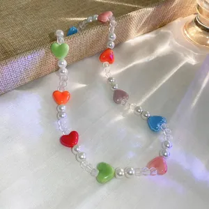 Detailed view of a charming necklace with vibrant heart beads and elegant white pearls