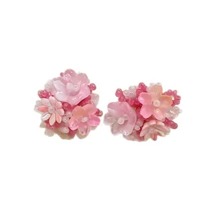 Sweet pink flower cluster earrings with seed beads and silver needles on white background