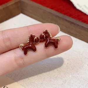 Elegant 18K gold plated horse stud earrings featuring a chic reddish brown enamel finish