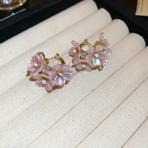 Elegant pink resin flower hoop earrings with pearl accents for women's holiday style.