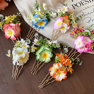 Gros plan d'épingles à cheveux en tissu plumeria coloré avec des tiges dorées élégantes