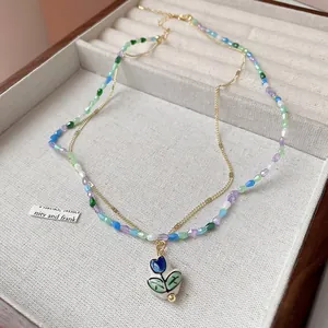 Close-up of colorful beaded necklace with elegant tulip pendant in jewelry box
