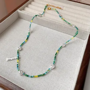 Macro view of a colorful beaded necklace with white pearls in a jewelry display box