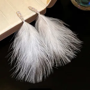 Elegant white feather tassel earrings with sparkling zircon studs and silver pins