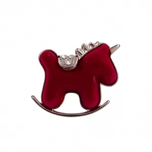 Red flocked rocking horse brooch with sparkling rhinestones and silver metal trim