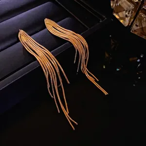 Elegant gold tassel drop earrings with delicate metallic chain design.