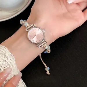 Elegant woven rope bracelet watch featuring ceramic beads and a pink sunray dial for women