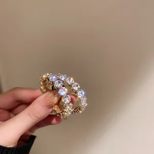 Elegant sparkling zirconia hoop earrings with luxury gold-tone finish and starburst effect.