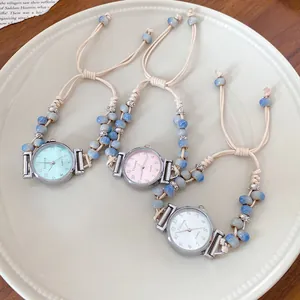 Close-up view of three woven wax rope watches with ceramic beads in soft pastel colors