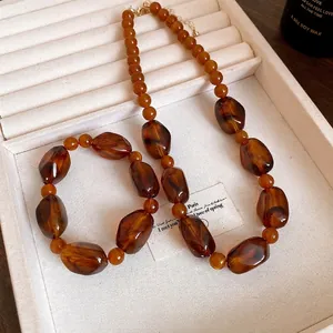 Vintage amber acrylic beaded necklace featuring irregular Maillard style resin beads