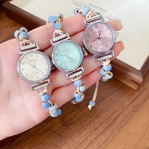 Three vintage woven ceramic bead bracelet watches in pink, green, and white colors.