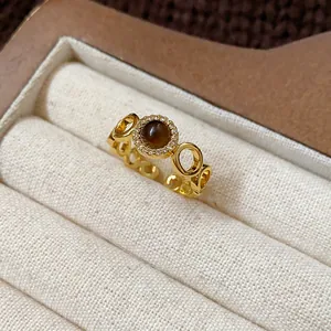 Close-up view of a gold-plated tiger eye ring with vintage aesthetic in a jewelry box