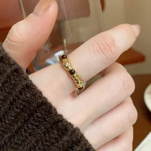 Macro detail of a vintage gold-plated ring set with polished natural tiger eye gemstones