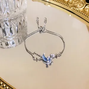 Silver-tone adjustable pull-out bracelet featuring blue moon and star zircon charms