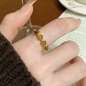 Detail view of gold-plated tiger eye stone adjustable ring in vintage Maillard style