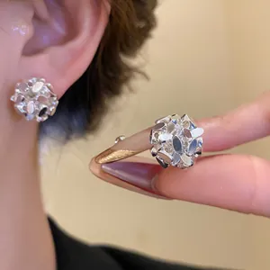 Detail view of 18k gold plated flower cluster ear clips with elegant vintage design.