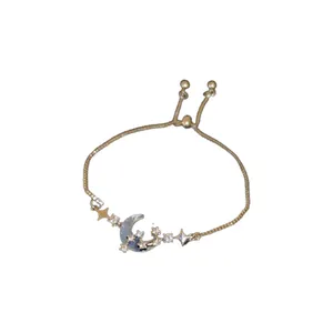 Elegant gold adjustable bracelet featuring a zircon crescent moon and sparkling star charms.
