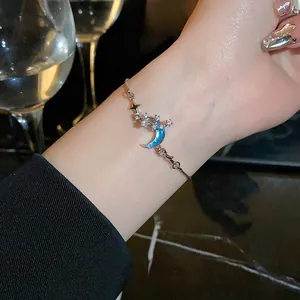 Close-up of elegant crescent moon and star adjustable bracelet with sparkling blue stones