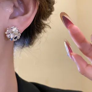 Detailed close-up of silver flower cluster clip-on earrings worn for a vintage look
