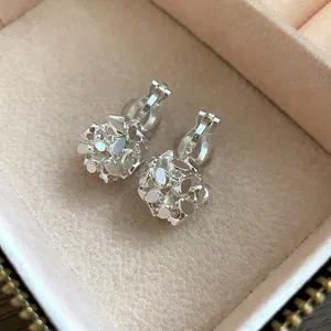 Close-up of vintage 18k gold plated flower cluster clip-on earrings in jewelry box