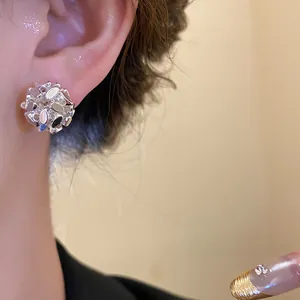Detailed view of vintage silver floral cluster clip-on earrings with 18k gold plating
