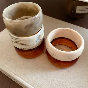 Detailed close-up view of stacked marble and tortoiseshell patterned acrylic bangles