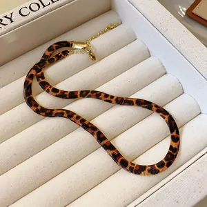 Stylish retro leopard print snake chain necklace shown in a soft beige jewelry tray