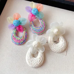 Handmade Bohemian mesh flower earrings with woven drop in vibrant and white colors.