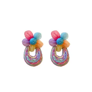 Vibrant bohemian mesh flower earrings with colorful woven hoops for holiday style.